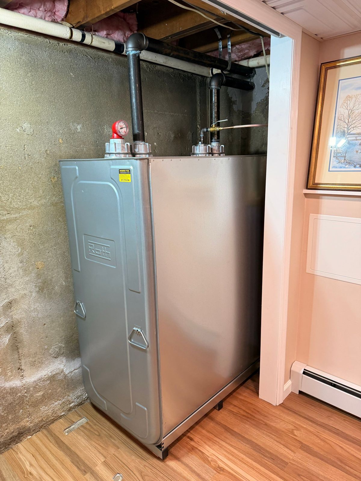 Roth oil tank installed in a Long Island basement with fill, vent, and gauge piping