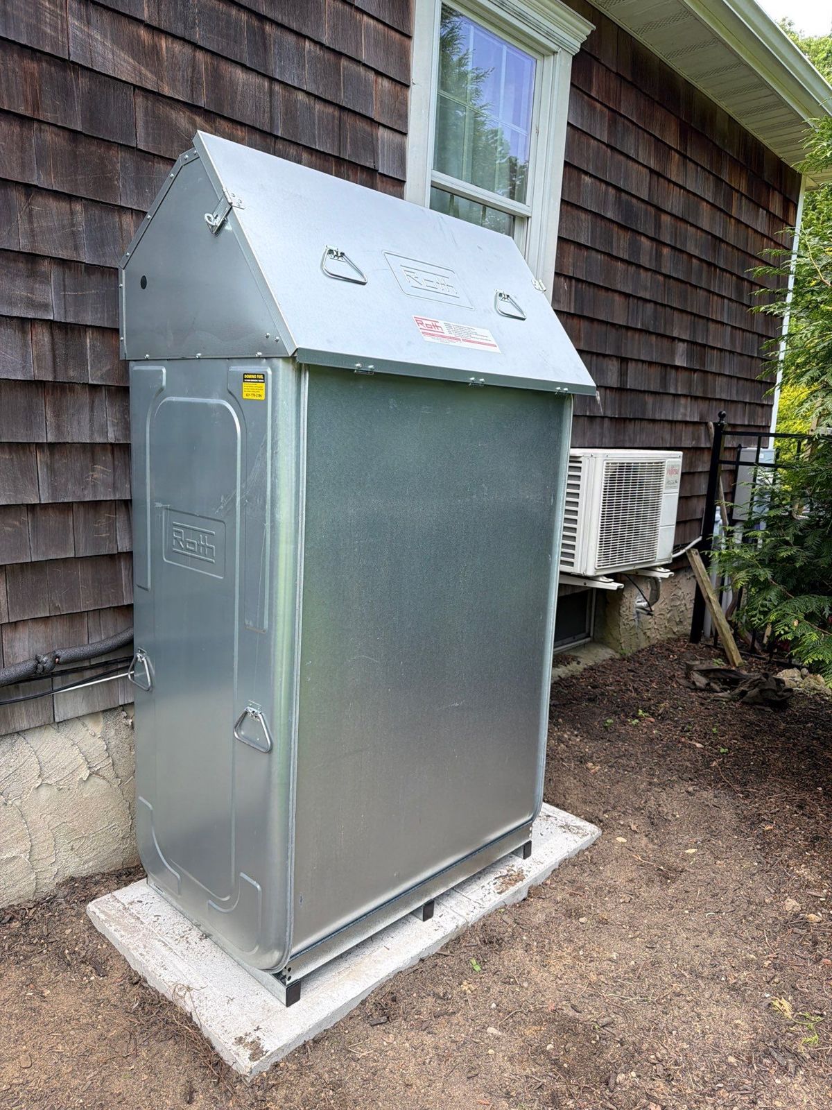 Roth outdoor oil tank installed on a concrete pad at a Long Island home by Domino Fuel