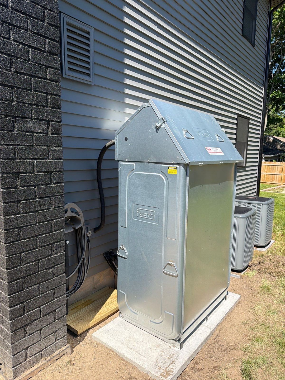 Roth outdoor oil tank with weather-protective cover installed by Domino Fuel on Long Island